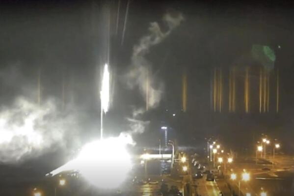 This image made from a video released by Zaporizhzhia nuclear power plant shows bright flaring object landing in grounds of the nuclear plant in Enerhodar, Ukraine Friday, March 4, 2022. Russian forces shelled Europe’s largest nuclear plant early Friday, sparking a fire as they pressed their attack on a crucial energy-producing Ukrainian city and gained ground in their bid to cut off the country from the sea. (Zaporizhzhia nuclear power plant via AP)