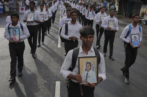 Sri Lankan Catholics carry portraits of the victims of the 2019 Easter Sunday attacks during its sixth anniversary commemoration in Colombo, Sri Lanka, Monday, April 21, 2025. (AP Photo/Eranga Jayawardena)