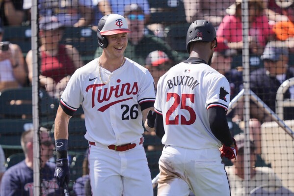 Minnesota Twins Byron Buxton is greeted by Max Kepler (26) after scoring on an RBI by Carlos Correa in the fourth inning of a spring training baseball game against the New York Yankees in Fort Myers, Fla., Saturday, March 9, 2024. (AP Photo/Gerald Herbert)