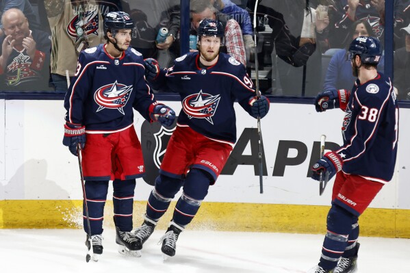 Columbus Blue Jackets forward Alexander Nylander, center, celebrates his goal against the San Jose Sharks with teammates forward Johnny Gaudreau, left, and forward Boone Jenner during the third period of an NHL hockey game in Columbus, Ohio, Saturday, March 16, 2024. The Blue Jackets won 4-2. (AP Photo/Paul Vernon)