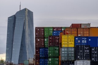 FILE - The European Central Bank is pictured next to containers in Frankfurt, Germany, on April 9, 2024. Inflation ticked up to an annual 2.6% in Europe in May, according to official figures on Friday, May 31, 2024. That's more than expected as a painful spike in consumer prices takes its time to fade away.(AP Photo/Michael Probst, File)