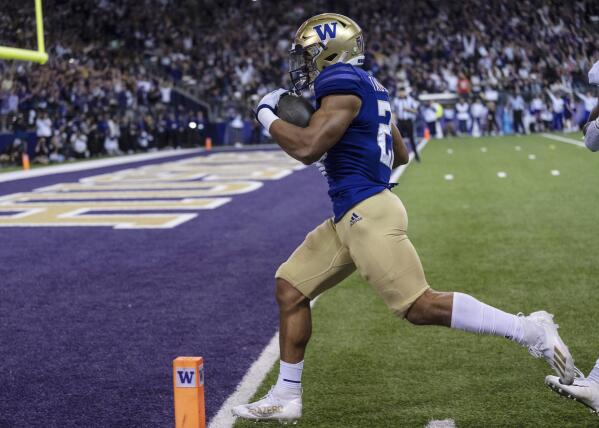 Washington running back Wayne Taulapapa scores a touchdown against Stanford during the first half of an NCAA college football game Saturday, Sept. 24, 2022, in Seattle. (AP Photo/Stephen Brashear)