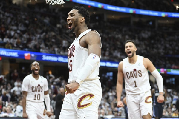 Cleveland Cavaliers' Donovan Mitchell (45) celebrates an offensive foul against the Orlando Magic during the second half in Game 1 of an NBA basketball first-round playoff series, Saturday, April 20, 2024, in Cleveland. (AP Photo/Nick Cammett)