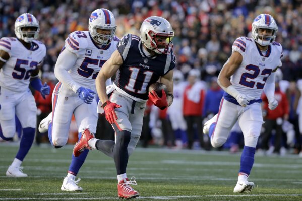 
              New England Patriots wide receiver Julian Edelman (11) runs from Buffalo Bills defenders Corey Thompson, left, Lorenzo Alexander and Micah Hyde, right, on his way to a touchdown after catching a pass during the second half of an NFL football game, Sunday, Dec. 23, 2018, in Foxborough, Mass. (AP Photo/Elise Amendola)
            