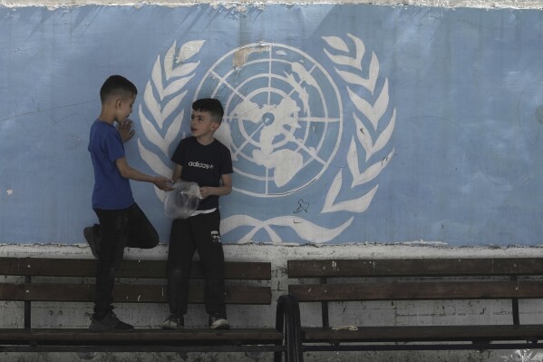 Students snack during recess in the yard of the UNRWA Boys' School run by the U.N. agency for Palestinian refugees in the Shuafat Refugee Camp in east Jerusalem, Tuesday, April 29, 2025. (AP Photo/Maya Alleruzzo)