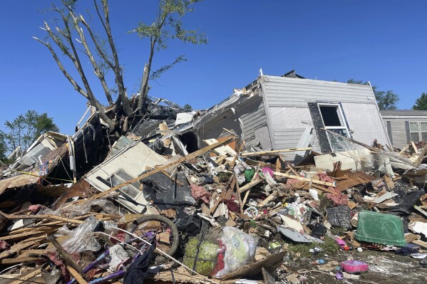 A storm-damaged mobile home is surrounded by debris at the Pavilion Estates mobile home park just east of Kalamazoo, Michigan, Wednesday, May 8, 2024. A tornado ripped through the area on the evening of May 7.  (AP Photo/Joey Cappelletti)