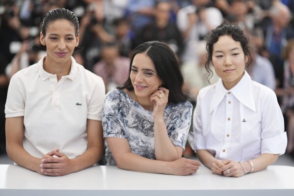 Nadia Melliti from left, director Hafsia Herzi and Park Ji-Min pose for photographers in the photo 