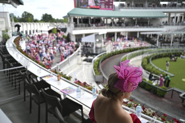 A fan looks out at the paddock at Churchill Downs before the 151st running of the Kentucky Oaks horse race Friday, May 2, 2025, in Louisville, Ky. (AP Photo/Jon Cherry)