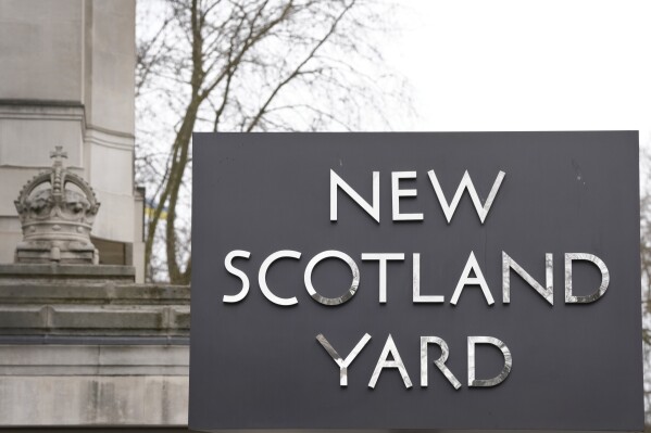 FILE - A sign outside New Scotland Yard, the headquarters of the London Metropolitan Police, in London, on March 21, 2023. The head of London’s police force is calling for increased legal protections for officers who use force in the line of duty after more than 100 officers refused to carry guns to protest murder charges filed against one of their colleagues. (AP Photo/Kirsty Wigglesworth, File)
