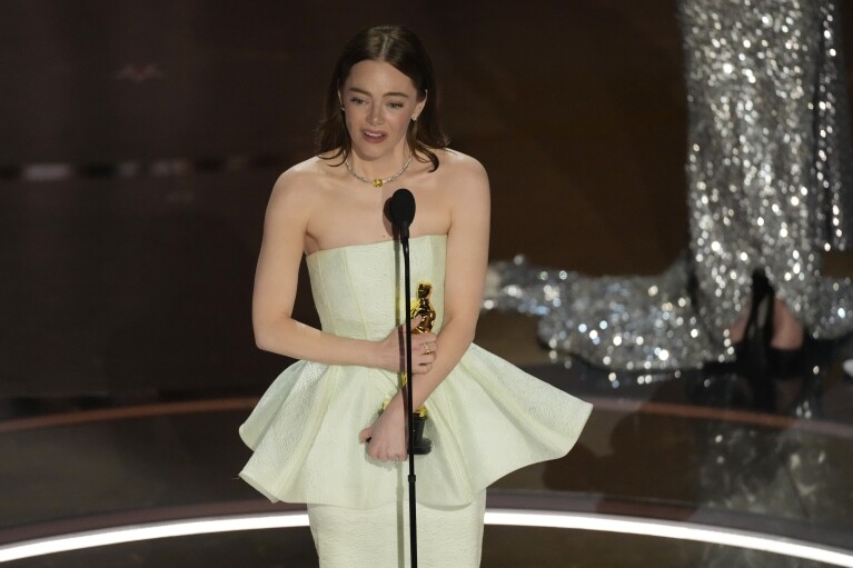 Emma Stone accepts the award for best performance by an actress in a leading role for "Poor Things" during the Oscars on Sunday, March 10, 2024, at the Dolby Theatre in Los Angeles. (AP Photo/Chris Pizzello)