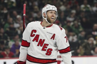 FILE - Carolina Hurricanes defenseman Jaccob Slavin reacts during the first period of an NHL hockey game against the Minnesota Wild, Tuesday, Feb. 27, 2024, in St. Paul, Minn. Slavin became a two-time winner of the NHL’s Lady Byng Memorial Trophy for sportsmanship and gentlemanly conduct on Thursday, May 30, 2024. (AP Photo/Stacy Bengs, File)