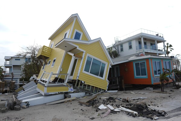 A house lies toppled off its stilts after the passage of Hurricane Milton, in Bradenton Beach on Anna Maria Island, Fla., Oct. 10, 2024. (AP Photo/Rebecca Blackwell, File)