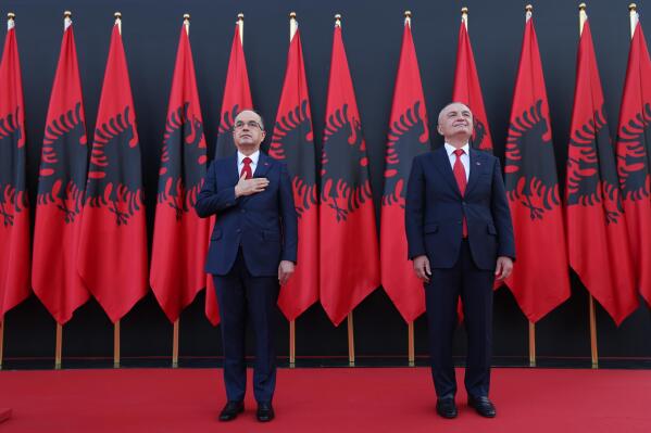 Newly appointed Albanian President Bajram Begaj, left, stands next to former President Ilir Meta, during an inauguration ceremony at the Presidential palace, in Tirana, Sunday, July 24, 2022. Albania's new president sworn in on Sunday calling on the country's political parties to cooperate and consolidate the rule of law. (AP Photo/Franc Zhurda)