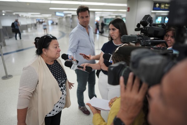 Magda Moreno, 58, a Cuban-American who had just arrived back from Havana, speaks to journalists at Miami International Airport, Monday, June 9, 2025, in Miami. (AP Photo/Rebecca Blackwell)