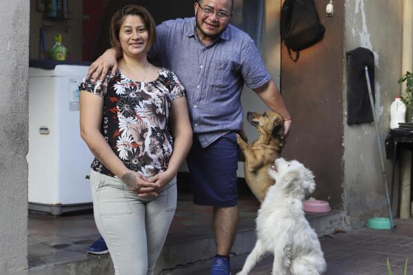 Fabricio Chicas, a transgender man, right, poses for a photo with his partner Elizabeth Lopez, and their pets, at their home in San Salvador, El Salvador, Sunday, April 30, 2023. Even though the country’s Supreme Court in 2022 determined that the inability of a person to change their name because of gender identity constitutes discriminatory treatment, the 49-year-old has not been able to change his name from Patricia to Fabricio, nor his gender on his ID, a fate shared by many transgender people in El Salvador. (AP Photo/Salvador Melendez)