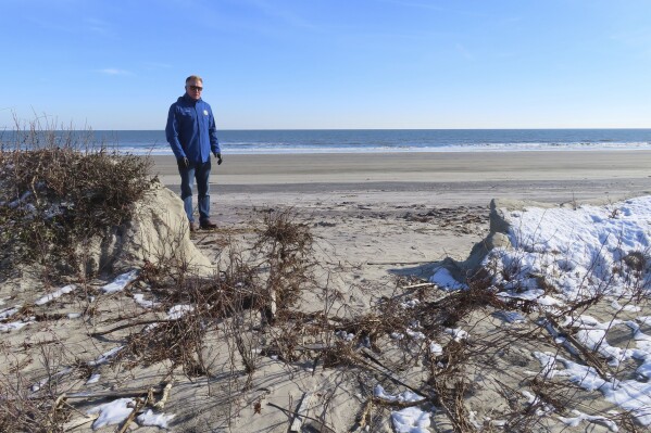 Mayor Patrick Rosenello stands next to a destroyed section of sand dune in North Wildwood N.J. on Jan. 22, 2024. (AP Photo/Wayne Parry)