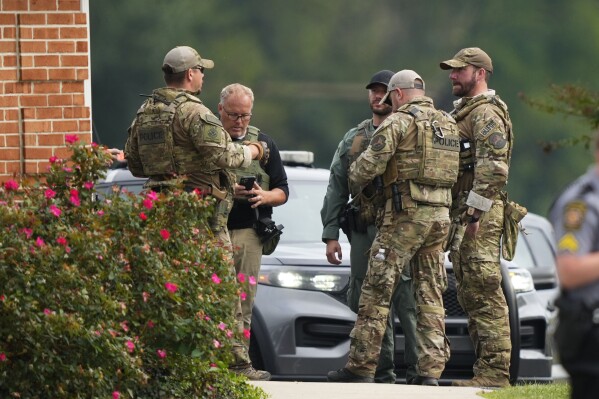 Law enforcement agents stand outside a Pennsylvania State Police barracks at Avondale Pa., where Danelo Cavalcante is being held on Wednesday, Sept. 13, 2023. Cavalcante was captured Wednesday after eluding hundreds of searchers for two weeks. (AP Photo/Matt Rourke)