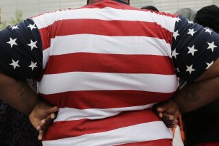FILE - In this May 8, 2014, file photo, an overweight person is seen in New York. As obesity rates climb in the U.S., more Americans say they’re following special diets compared to a decade ago. (A...