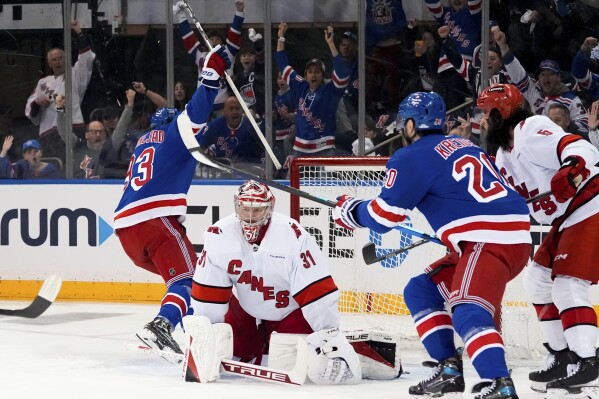 Carolina Hurricanes goaltender Frederik Andersen (31) looks on as New York Rangers center Mika Zibanejad and left wing Chris Kreider celebrate following Zibanejad's goal during the first period in Game 1 of an NHL hockey Stanley Cup second-round playoff series, Sunday, May 5, 2024, in New York. (AP Photo/Julia Nikhinson)