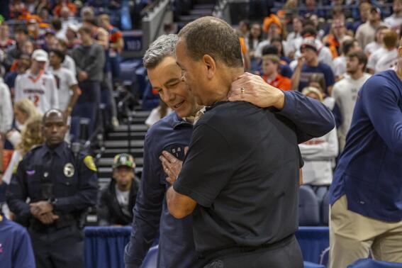 Virginia head coach Tony Bennett, left, and Houston head coach Kelvin Sampson greet each other before an NCAA college basketball game in Charlottesville, Va., Saturday, Dec. 17, 2022. (AP Photo/Erin Edgerton)