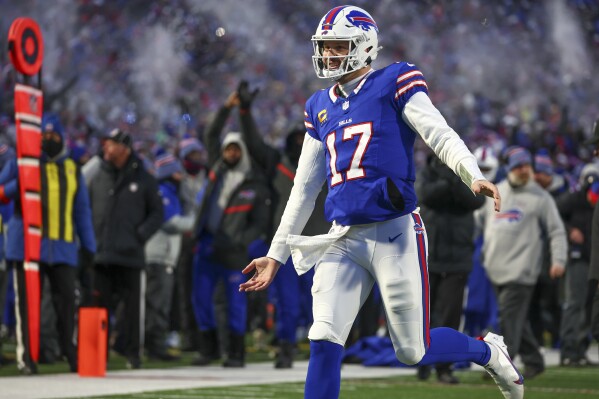 Buffalo Bills quarterback Josh Allen (17) reacts after throwing a touchdown pass to tight end Dalton Kincaid (86) during the first quarter of an NFL wild-card playoff football game, Monday, Jan. 15, 2024, in Buffalo, N.Y. (AP Photo/Jeffrey T. Barnes)