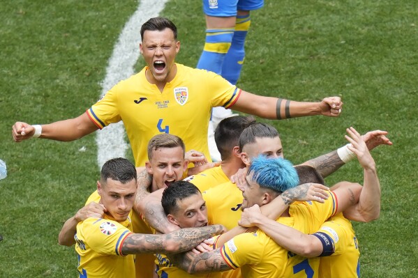 Romania players celebrate their win against Ukraine after the end of a Group E match between Romania and Ukraine at the Euro 2024 soccer tournament in Munich, Germany, Monday, June 17, 2024. (AP Photo/Ariel Schalit)