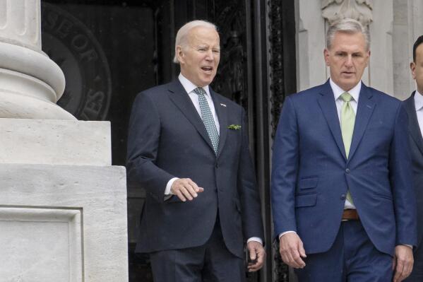 FILE - President Joe Biden talks with House Speaker Kevin McCarthy, R-Calif., as he departs the Capitol following the annual St. Patrick's Day gathering, in Washington, March 17, 2023. There are stark differences in how President Joe Biden and House Speaker Kevin McCarthy want to shore up the government's finances. The Democratic president primarily wants higher taxes on the wealthy to lower deficits; the GOP congressional leader favors sharp spending cuts. (AP Photo/J. Scott Applewhite, File)