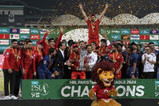 Islamabad United' players and officials celebrate with trophy after winning the final of Pakistan Super League T20 cricket match against Multan Sultans, in Karachi, Pakistan, Monday March 18, 2024. (AP Photo/Fareed Khan)