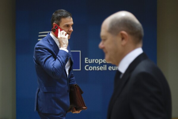 Germany's Chancellor Olaf Scholz, right, and Spain's Prime Minister Pedro Sanchez arrive for a round table meeting at an EU summit in Brussels, Friday, Dec. 15, 2023. European Union leaders conclude a second day of meetings on Friday in which they will discuss the situation in Gaza. (AP Photo/Omar Havana)