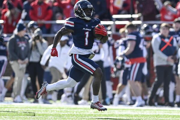 Liberty running back Shedro Louis runs the ball for a touchdown against Virginia Tech during an NCAA college football game in Lynchburg, Va., Saturday, Nov. 19, 2022. (Paige Dingler/The News & Advance via AP)