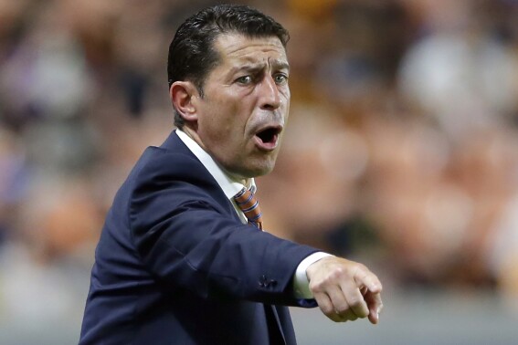 FILE — Houston Dynamo head coach Tab Ramos gestures during the second half of an MLS soccer match against FC Cincinnati, July 3, 2021, in Houston. Ramos was hired Tuesday, Sept. 19, 2023, as an assistant coach by the New England Revolution, whose staff has been in transition.(AP Photo/Michael Wyke, File)