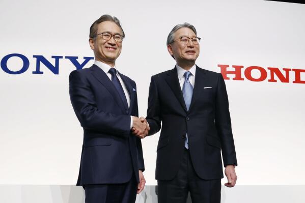 Sony Group Corp.'s Chief Executive Kenichiro Yoshida, left, and Honda Motor Co.'s Chief Executive Toshihiro Mibe, right, shake hands at a press conference in Tokyo Friday, March 4, 2022. Two big names in Japanese electronics and autos are joining forces to produce an electric vehicle together.
Sony Group Corp. and Honda Motor Co. agreed to set up a joint venture this year to start selling an electric vehicle by 2025, both sides said Friday. (Jun Hirata/Kyodo News via AP)