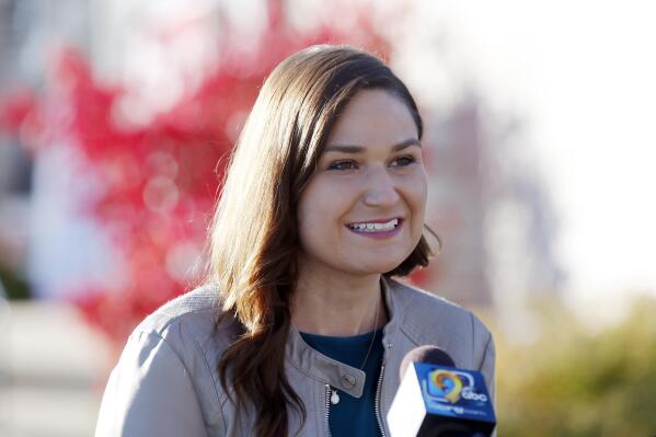 FILE - In this Nov. 3, 2020 file photo, Abby Finkenauer talks with journalists at the Linn County Democrats' office in Cedar Rapids, Iowa. A state court judge has concluded that Democrat Abby Finkenauer cannot appear on the June 7 primary ballot for U.S. Senate, knocking off the candidate considered by many to be the party's leader in the effort to challenge U.S. Sen. Charles Grassley. (Liz Martin/The Gazette via AP, File)