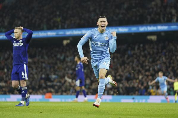 Manchester City's Phil Foden celebrates after scoring his side's opening goal during the English Premier League soccer match between Manchester City and Leeds United at Etihad stadium in Manchester, England, Tuesday, Dec. 14, 2021. (AP Photo/Jon Super)