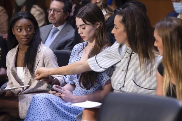 United States gymnasts from left, Simone Biles, McKayla Maroney, Aly Raisman and Maggie Nichols, arrive to testify during a Senate Judiciary hearing about the Inspector General's report on the FBI's handling of the Larry Nassar investigation on Capitol Hill, Wednesday, Sept. 15, 2021, in Washington. Nassar was charged in 2016 with federal child pornography offenses and sexual abuse charges in Michigan. He is now serving decades in prison after hundreds of girls and women said he sexually abused them under the guise of medical treatment when he worked for Michigan State and Indiana-based USA Gymnastics, which trains Olympians. (Saul Loeb/Pool via AP)