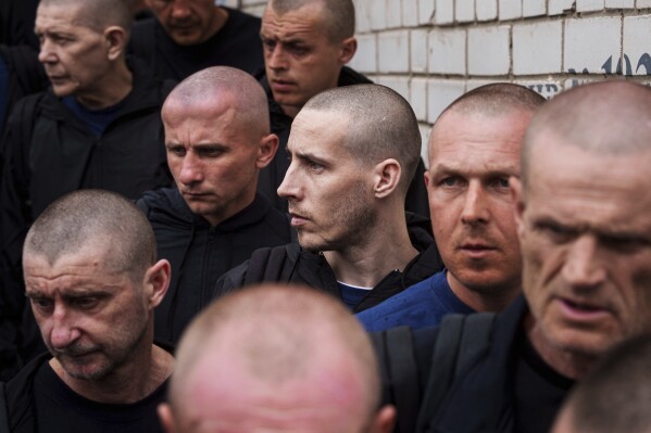 Ukrainian soldiers walk after a POWs exchange between Russia and Ukraine, in Chernyhiv region, Ukraine, Saturday, May 24, 2025. (AP Photo/Evgeniy Maloletka)