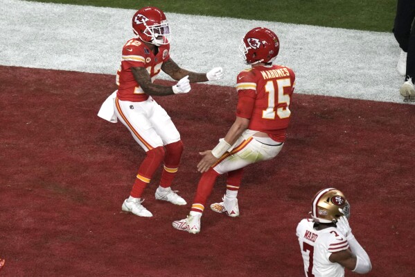 Kansas City Chiefs wide receiver Mecole Hardman Jr. (12) celebrates after scoring the winning touchdown with quarterback Patrick Mahomes (15) in overtime during the NFL Super Bowl 58 football game Sunday, Feb. 11, 2024, in Las Vegas. The Kansas City Chiefs won 25-22 against the San Francisco 49ers. (AP Photo/Charlie Riedel)