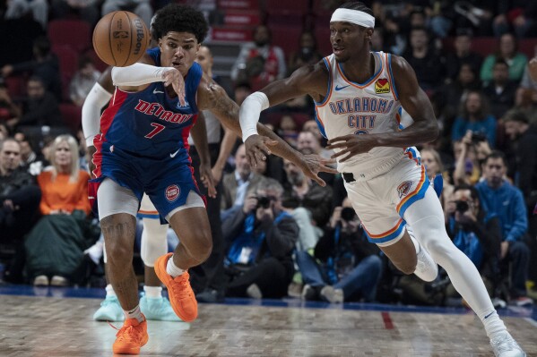 Oklahoma City Thunder's Shai Gilgeous-Alexander, right, and Detroit Pistons' Killian Hayes (7) vie for the ball during the first half of an NBA preseason basketball game Thursday, Oct. 12, 2023, in Montreal. (Christinne Muschi/The Canadian Press via AP)
