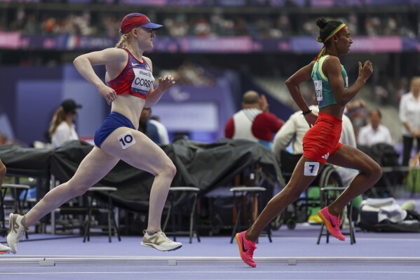 Liza Corso from the U.S., left, works her way through the pack and on to a bronze medal during the 1500 meter T13 race at the Paralympic Games in Paris, Saturday, Aug. 31, 2024. (AP Photo/Avni Trivedi)