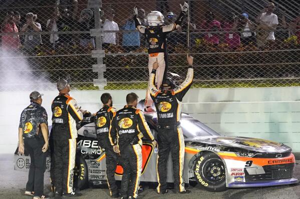 Noah Gragson celebrates on the roof of his car after winning the NASCAR Xfinity Series auto race at Homestead-Miami Speedway, Saturday, Oct. 22, 2022, in Homestead, Fla. (AP Photo/Lynne Sladky)