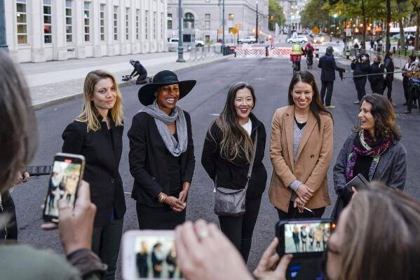 FILE — In this Oct. 27. 2020 file photo, Nicki Clyne, left, Michelle Hatchette, second from left, Linda Chung, center, and Dr. Danielle Roberts, right, speak outside Brooklyn federal court following the sentencing hearing for self-improvement guru Keith Raniere, in New York. New York health officials have revoked the medical license of Roberts, Friday, Oct. 1, 2021,  who branded 17 women with the initials of the cult-like group's leader, Keith Raniere. (AP Photo/Frank Franklin II, File)