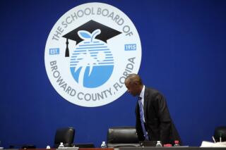 FILE - Broward County Schools Superintendent Robert Runcie gets up during a break of a meeting of the Broward County School Board on March 5, 2019, in Fort Lauderdale, Fla. A Florida grand jury empaneled after a 2018 school massacre has recommended on Friday, Aug. 19, 2022, that Gov. Ron DeSantis remove from office four members of the Broward County school board, saying they and district administrators displayed “deceit, malfeasance, misfeasance, neglect of duty and incompetence” in their handling of a campus safety program. Runcie resigned last year after he was indicted for allegedly lying to the grand jury. (AP Photo/Lynne Sladky, File)