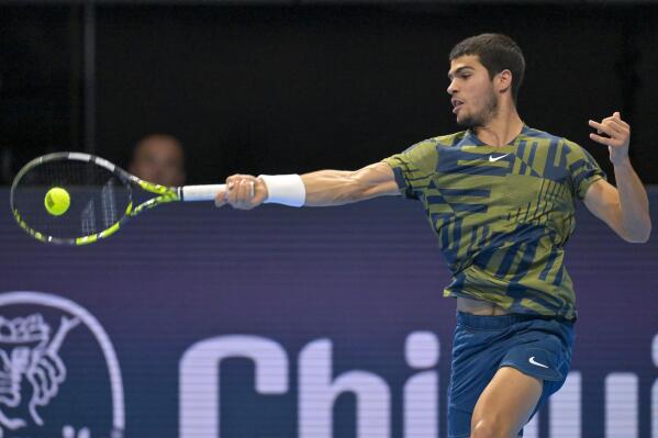 Spain's Carlos Alcaraz returns a ball to Spain's Pablo Carreno Busta during their quarterfinal match at the Swiss Indoors tennis tournament at the St. Jakobshalle in Basel, Switzerland, Friday, Oct. 28, 2022. (Georgios Kefalas/Keystone via AP)