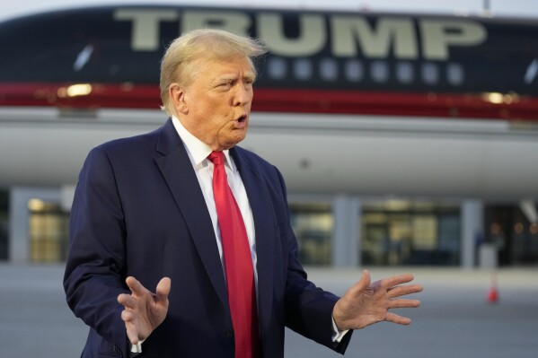 FILE - Former President Donald Trump speaks with reporters before departure from Hartsfield-Jackson Atlanta International Airport, Thursday, Aug. 24, 2023, in Atlanta. Trump has called for the impeachment and removal of Fulton County District Attorney Fani Willis because of his indictment over efforts to overturn his 2020 election loss in Georgia. (AP Photo/Alex Brandon, File)