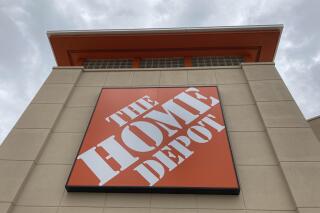 FILE - A Home Depot logo sign hands on its facade, Friday, May 14, 2021, in North Miami, Fla. Home Depot's sales rose in its fiscal second quarter, buoyed by continued demand for items related to home improvement projects. (AP Photo/Wilfredo Lee, File)