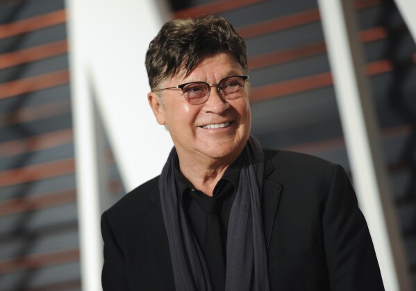 FILE - Musician Robbie Robertson arrives at the Vanity Fair Oscar Party on Sunday, Feb. 22, 2015, in Beverly Hills, Calif. Robertson, the lead guitarist and songwriter for The Band, whose classics include “The Weight,” “Up on Cripple Creek” and “The Night They Drove Old Dixie Down,” has died at 80, according to a statement from his manager. (Photo by Evan Agostini/Invision/AP, File)