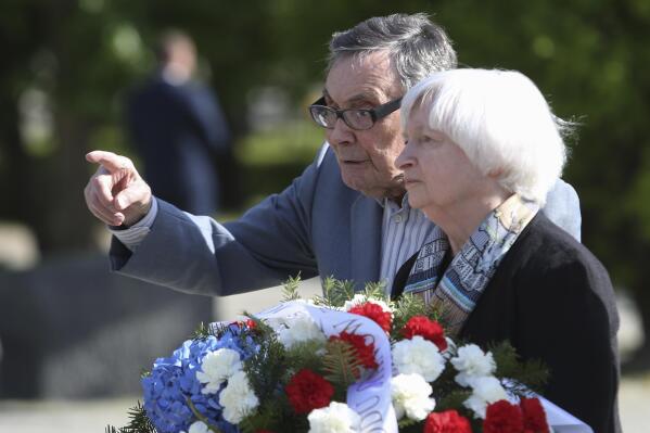 U.S Treasury Secretary Janet Yellen, right, talks to Holocaust survivor, Marian Turski, while attending a wreath-laying ceremony in front of the Ghetto Heroes Monument in Warsaw, Poland, Monday, May 16, 2022. (AP Photo/Michal Dyjuk)