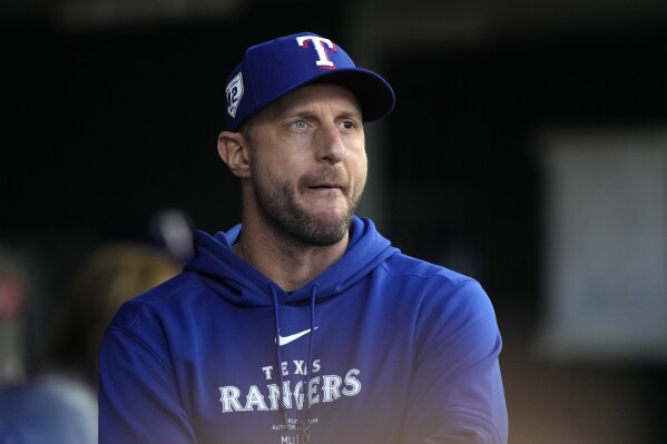 Texas Rangers pitcher Max Scherzer watches from the dugout during the fourth inning of a baseball game against the Detroit Tigers, Monday, April 15, 2024, in Detroit. (AP Photo/Carlos Osorio)