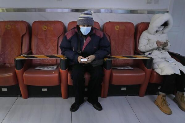 A resident waits in a community health clinic in Beijing, Thursday, Dec. 15, 2022. A week after China eased some of the world's strictest COVID-19 containment measures, uncertainty remains over the direction of the pandemic in the world's most populous nation. (AP Photo/Ng Han Guan)