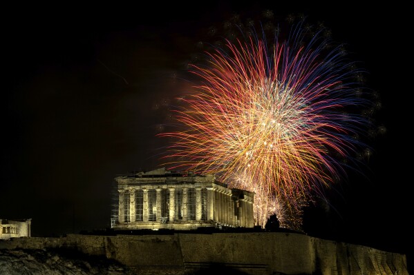 Fireworks explode over the ancient Parthenon temple at the Acropolis hill during New Year's celebrations in Athens, Greece, Monday, Jan. 1, 2024. (AP Photo/Yorgos Karahalis)